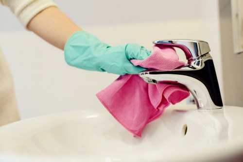 Professional cleaner handling kitchen surfaces in Brentford area